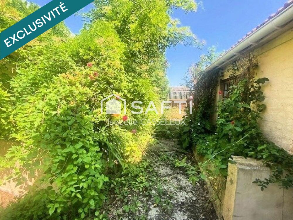 Maison de ville en briques de 110 m²  2 chambres, garage, dépendances et jardin à Guise