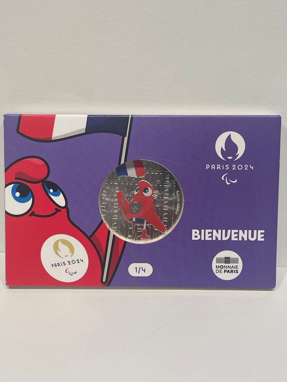 
Monnaie 50e en argent coloris&eacute;e JO 2024 - Mascotte Drapeau 