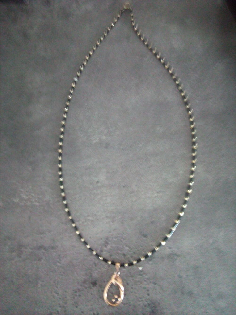 Collier noir/dore avec pendentif Bijoux et montres