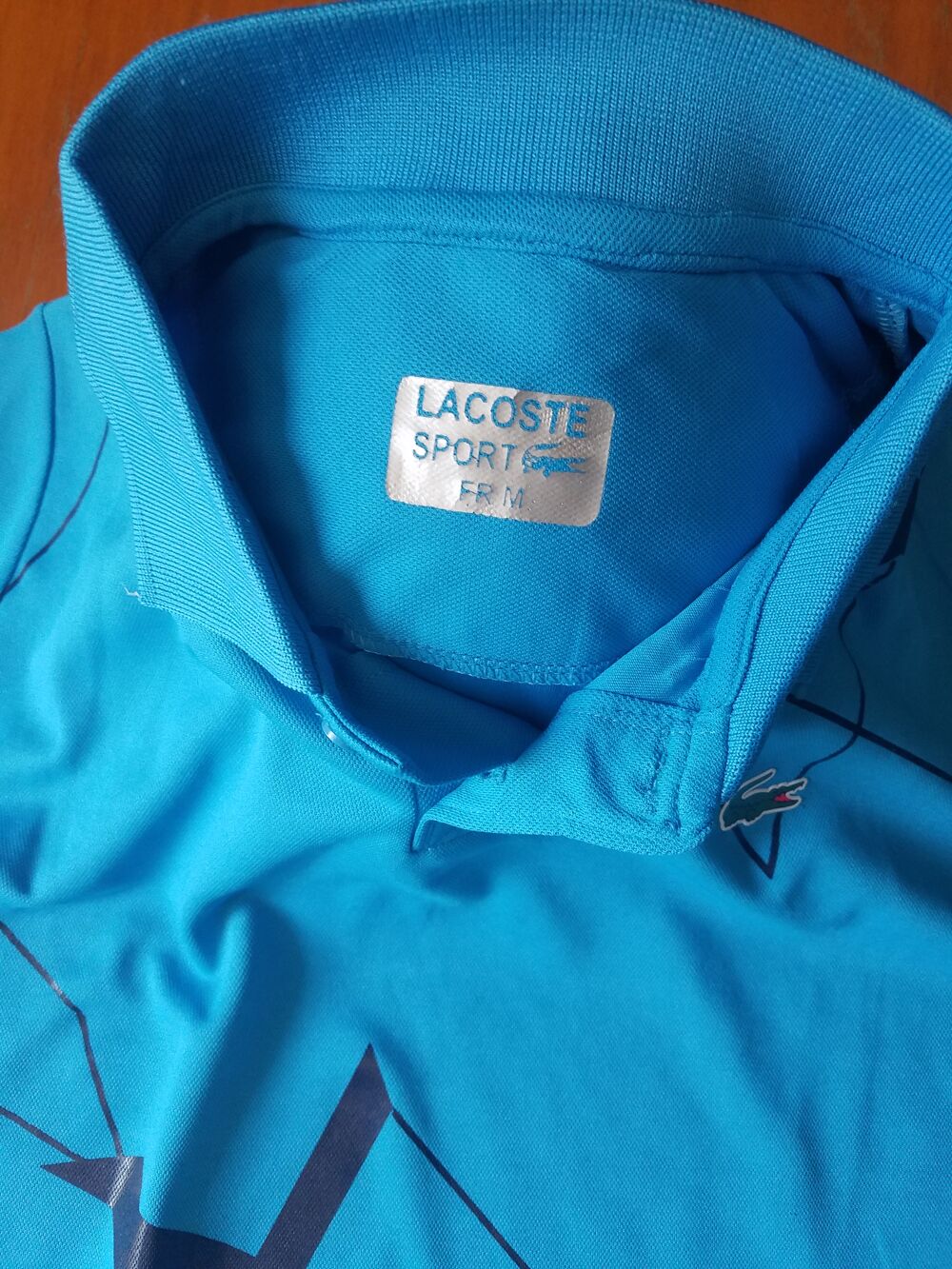 Polo bleu Lacoste en bon &eacute;tat Vêtements