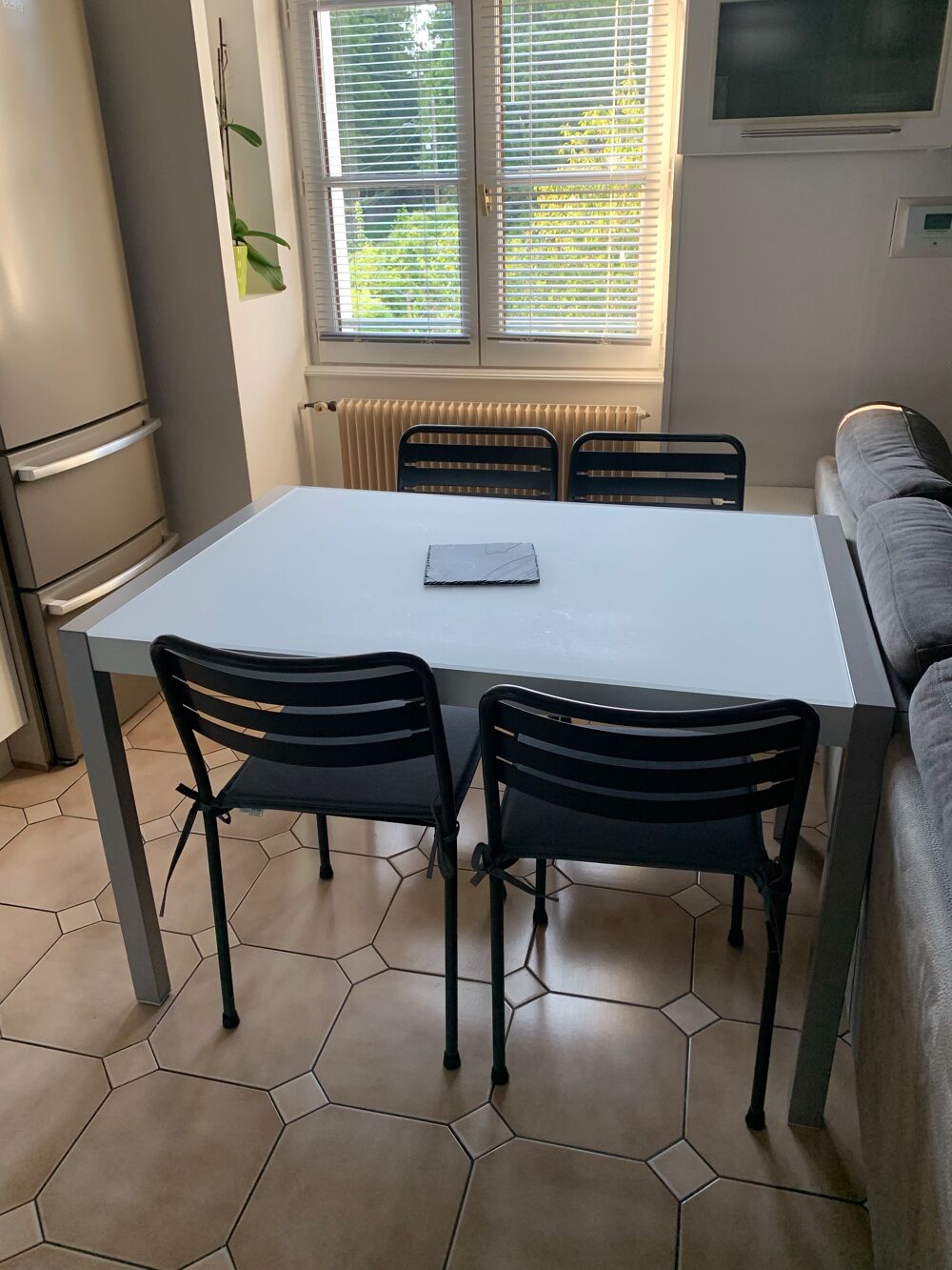 tr&egrave;s belle table en verre mat quatre pieds. Meubles