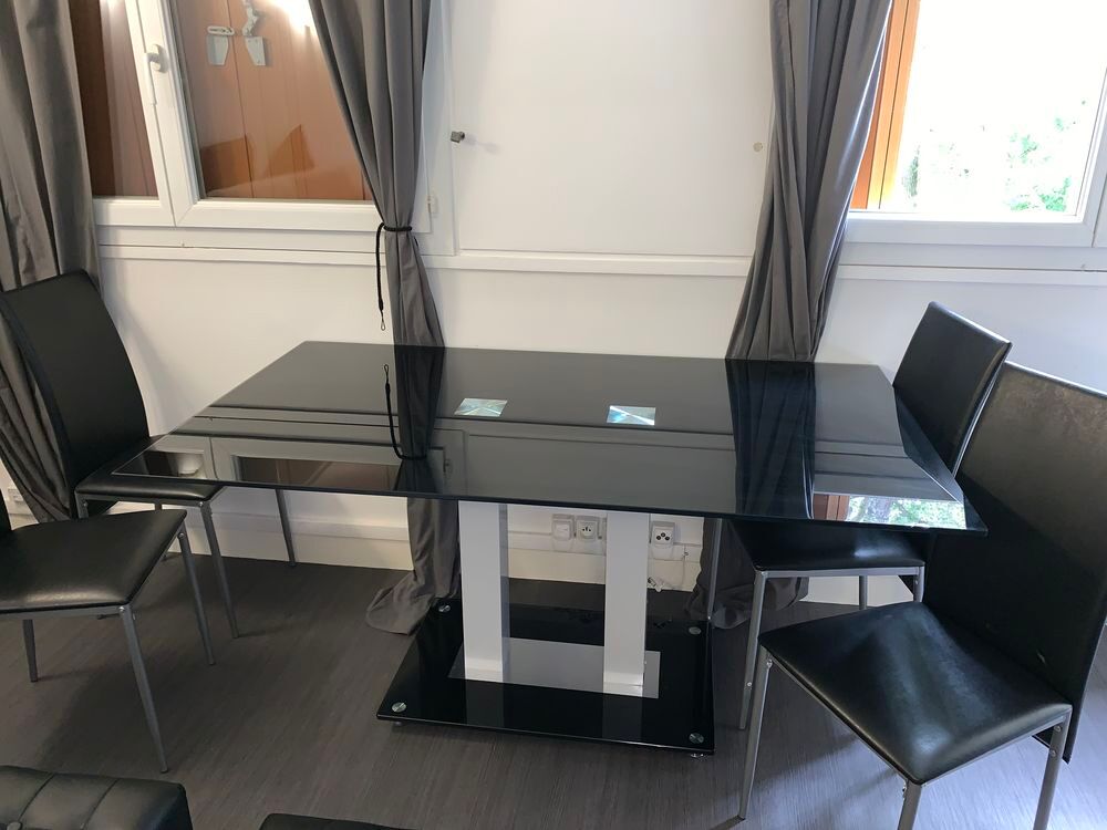 Une grande table en verre noir , 4 chaises et 2 poufs Meubles