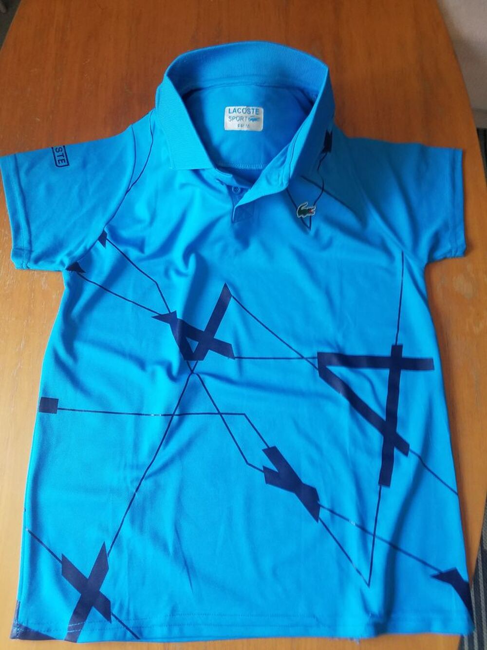 Polo bleu Lacoste en bon &eacute;tat Vêtements