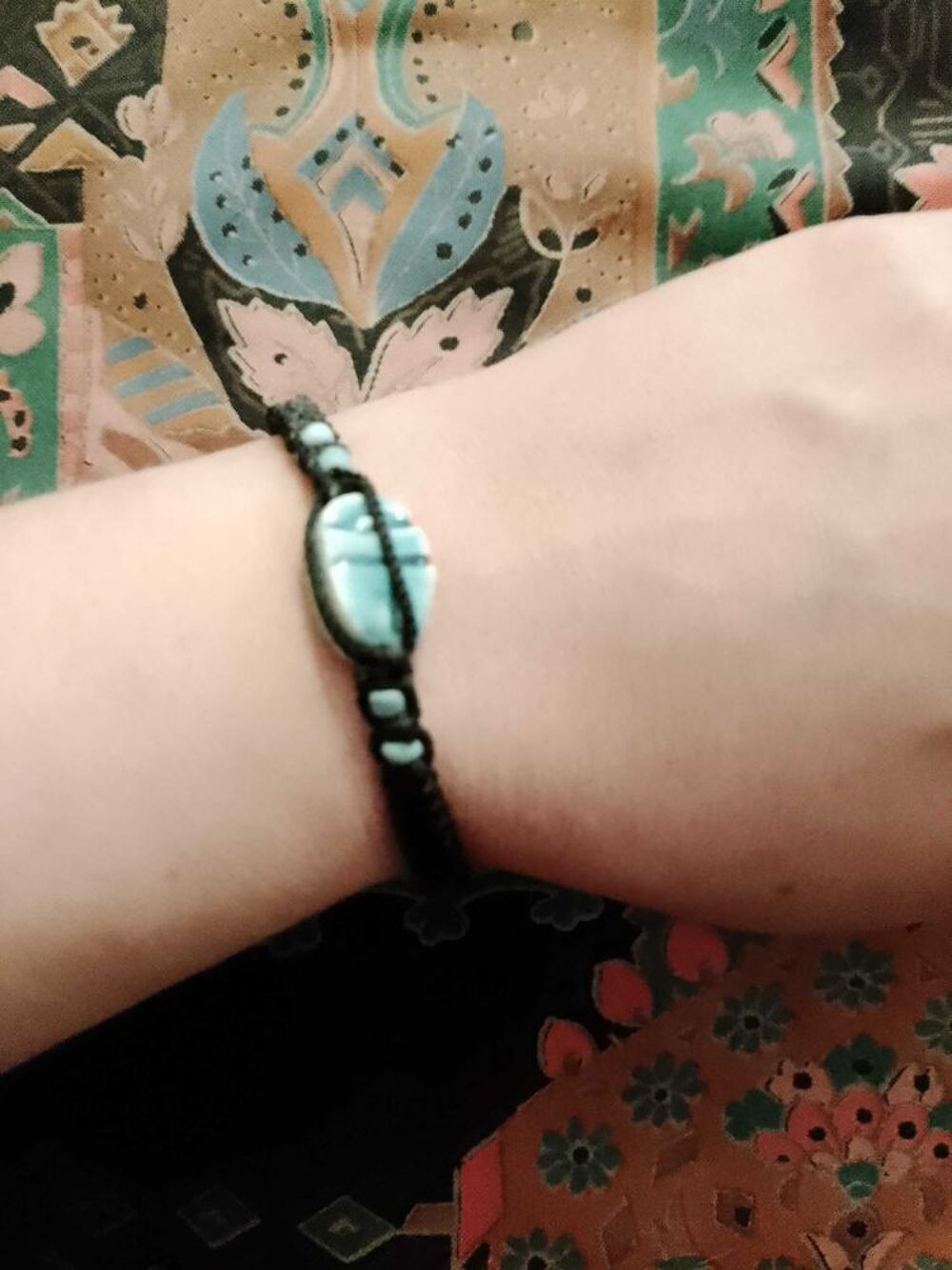 bracelet en fils noir et perle en c&eacute;ramique bleue claire. Bijoux et montres