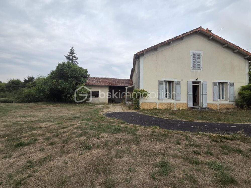 Maison à rénover avec potentiel, grand garage et jardin clos de 1200 m²