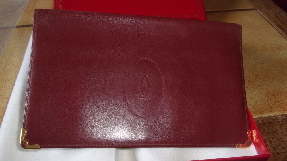 PORTEFEUILLE PORTE CARTES CARTIER CUIR BORDEAUX.
Maroquinerie